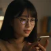 Woman With Glasses Using Smartphone At Night