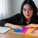 Woman With Notebooks And Desk Lamp