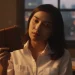 Woman Holding Leather Journal Night Window