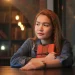 Young Woman Holding Book In Library